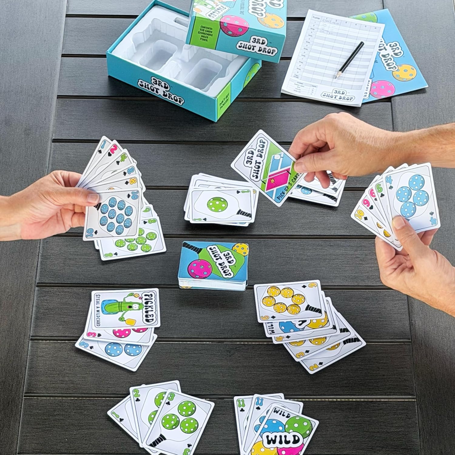Two players holding 3rd Shot Drop cards during a game